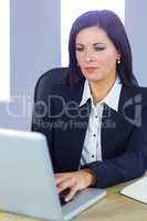 Businesswoman working at her desk