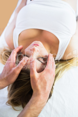 Relaxed pregnant woman enjoying reiki technique