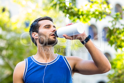 An handsome athlete drinking water