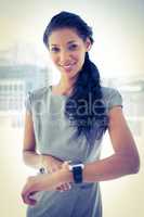Smiling businesswoman using her smartwatch