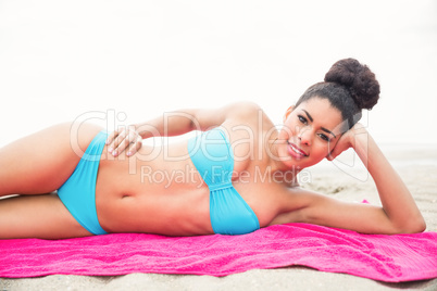 Slim woman sunbathing on towel