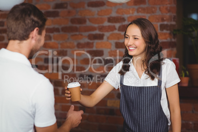 Pretty smiling barista serving a customer