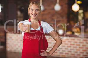 Pretty waitress handing a mug of coffee