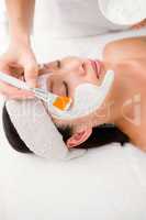 Attractive woman receiving treatment at spa center