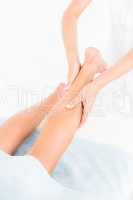 Female masseur massaging womans leg