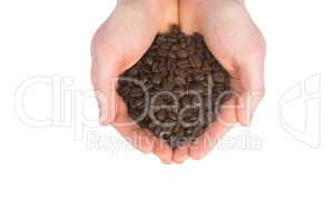 Close up view of hands showing coffee beans