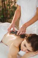 Young woman getting a hot stone massage