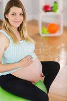Portrait of pregnant woman sitting on exercise ball