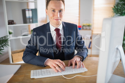 Stylish businessman working at his desk