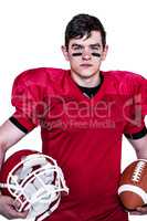 American football player holding helmet and a ball