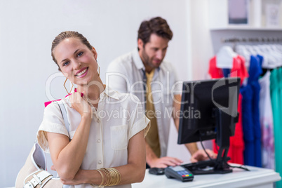 Smiling woman standing in front of till