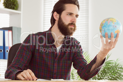 Hipster businessman with a globe