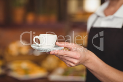 Barista offering cup of coffee