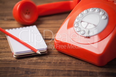 Telephone on table with notepad