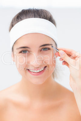 Hand applying eyeshadow to beautiful woman