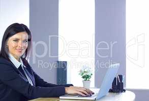 Businesswoman working on laptop at her desk