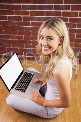 Portrait of a beautiful woman with laptop on her knee