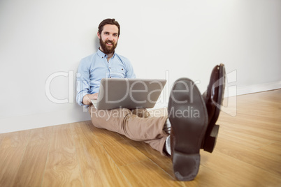 Handsome hipster using his laptop