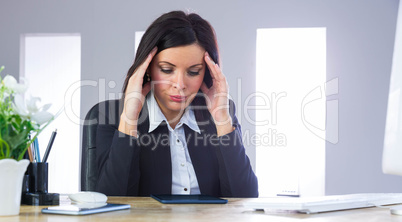 Stressed businesswoman working at her desk