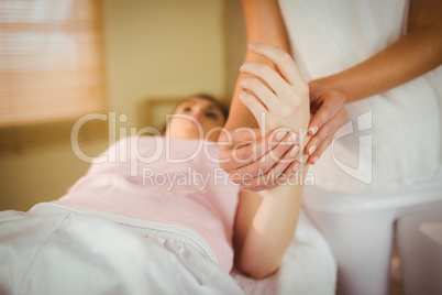 Young woman getting hand massage