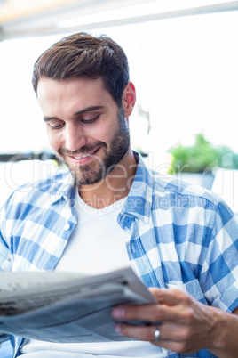 Young man reading the newspapers