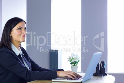Businesswoman working on laptop at her desk Businesswoman working on laptop at her desk