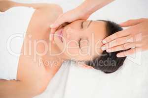 Attractive young woman receiving head massage