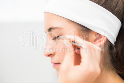 Hand applying eyeshadow to beautiful woman