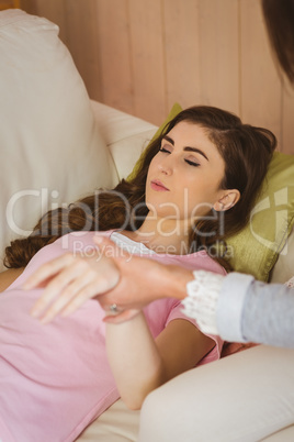 Hypnotherapist holding her patients wrist