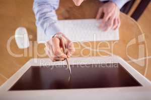 Businessman pointing to screen with pen