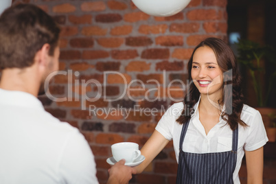 Pretty smiling barista serving a customer