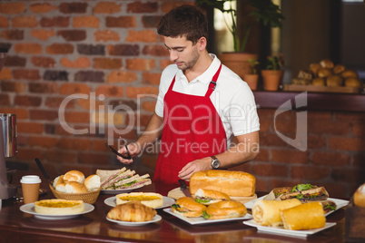 Handsome waiter about to pick a roll