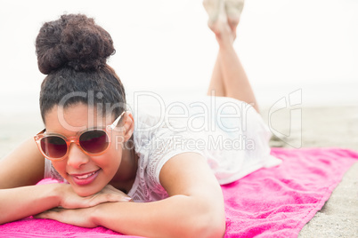 Smiling woman lying on towel