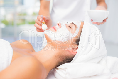 Attractive woman receiving treatment at spa center