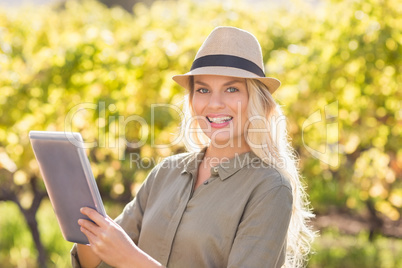 Smiling blonde woman using a tablet