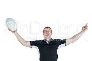 A rugby player gesturing victory