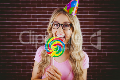 A beautiful hipster holding a giant lollipop