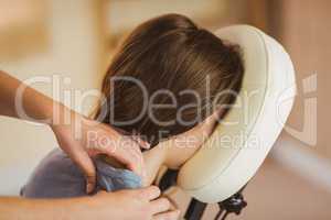 Young woman getting massage in chair