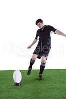 Rugby player doing a drop kick