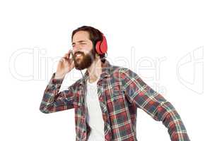 Handsome hipster enjoying listening to music