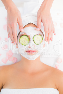 Attractive woman receiving cucumber treatment