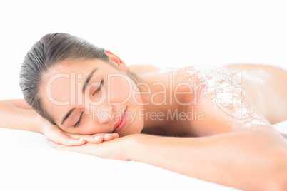 Beautiful brunette enjoying a salt scrub treatment