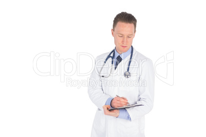 Serious doctor writing on a clipboard