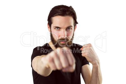 Handsome hipster punching at camera