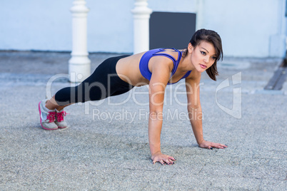 Focused athletic woman doing push-ups