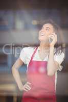 Smiling waitress talking on the phone