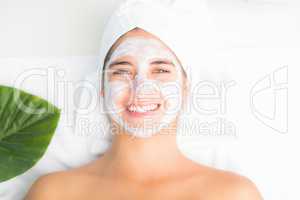 Attractive woman having white cream on her face