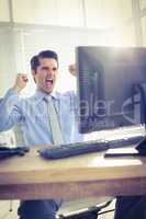 Cheerful businessman cheering in office