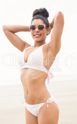 Fit woman in bikini smiling at camera