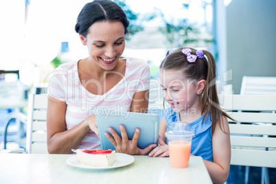 Mother and daughter using tablet computer together